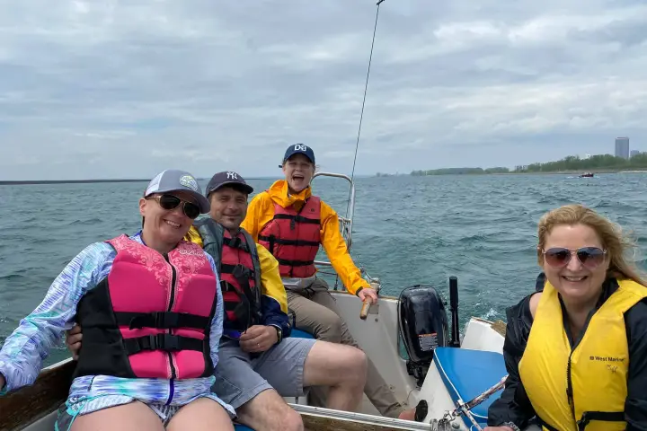 a group of people sitting in a boat on a body of water