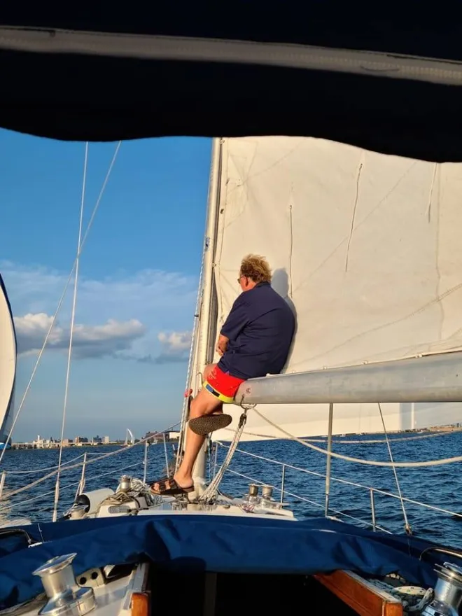 303285052_535232235276434_27227026002733527_n a man standing on a boat
