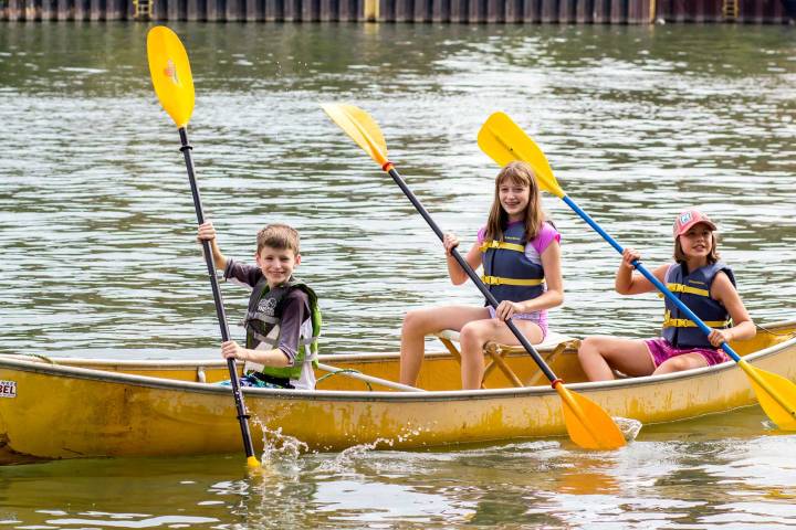 a group of people rowing a boat in the water