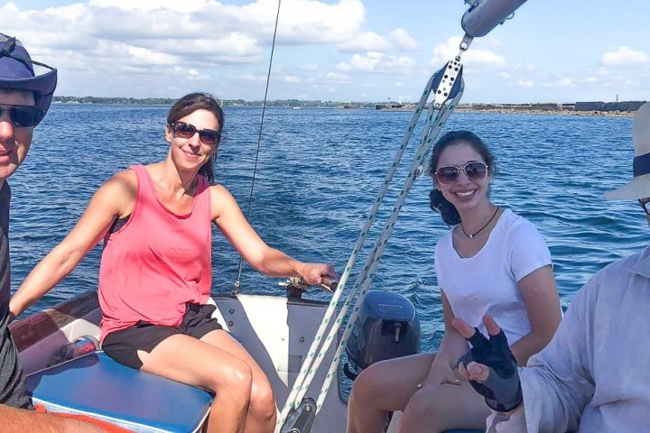 a group of people sitting in a boat on a body of water