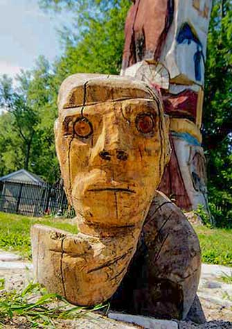 a person standing in front of a large rock